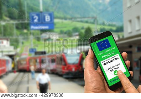 Man In A Train Station Is Holding Smartphone With The European Union Digital Green Pass For Covid-19
