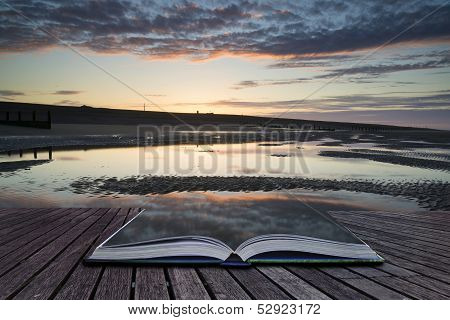 Creative Concept Pages Of Book Vibrant Sunrise Landscape Reflected In Low Tide Water On Beach