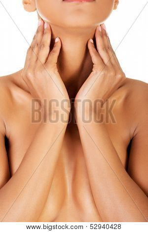 Beautiful naked women is covering her breasts and holing her neck. Isolated on white. 