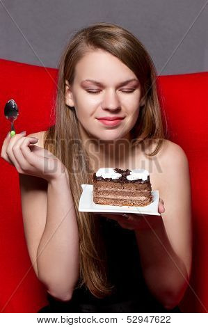 a Cheerful woman eating chocolade a pie