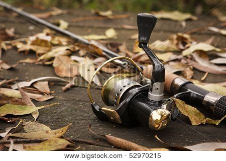 Fishing Tackle On Wooden Surface.