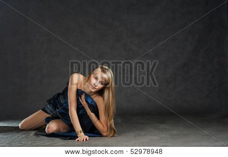 Beautiful model dressed in fabrick laying on floor