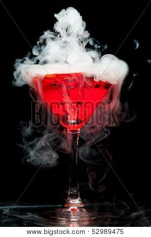 red cocktail with ice vapor