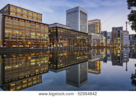 Marunouchi, Tokyo, Japan buildings reflect on the Imperial Palace moat.