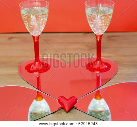 Mirroring Of Two Champagne Glasses And Little Heart