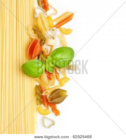 Heap of different type of pasta and basil leaf on white background
