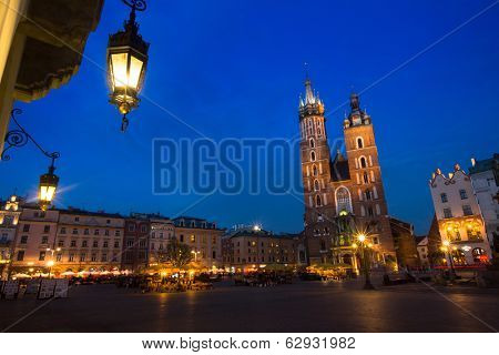 KRAKOW, POLAND - APR 7, 2014: St. Mary's Church on Rynek Glowny (Market Square) in night time. Rynek Glowny - roughly 40,000 m2 is largest medieval town square in Europe.
