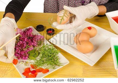 Hands decorating Easter eggs