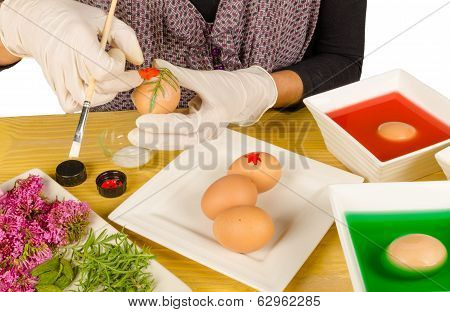 Hands decorating Easter eggs