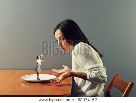 small discontented woman screaming at big businesswoman