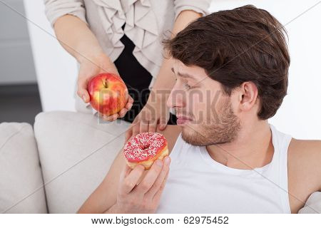 Man Choosing Donut Instead Of Apple