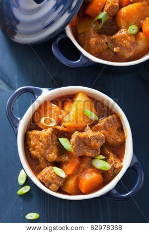 beef stew with potato and carrot in blue pots 