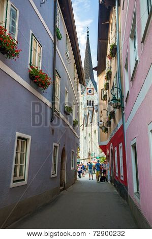 Typical Street With Tourists In Front Of The Halstatt Village Church