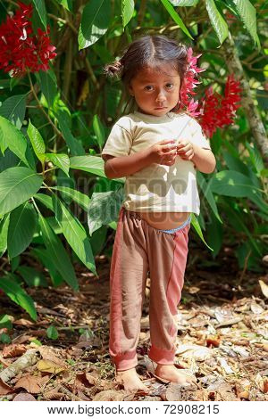 Yasuni, Ecuador - 17 November 2012: Young Indigenous Girl Looking Scared Straight To The Camera, South America In Yasuni On November 17, 2012