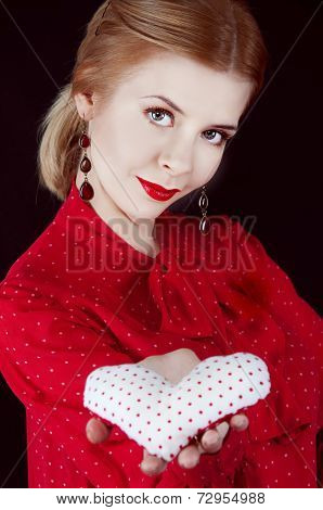 Beautiful young blonde woman with fabric heart