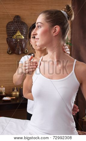 Young woman enjoying traditional thai massage in asia.