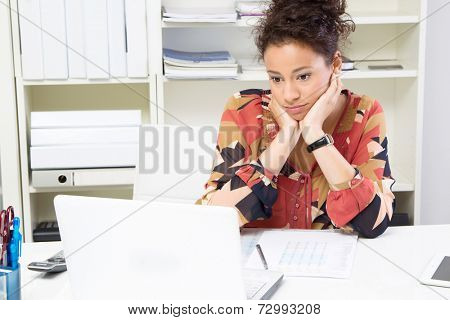 Young woman bored while working in office