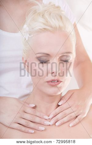 Eyes closed female getting decollete massage