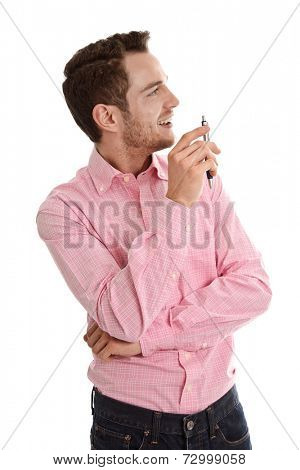 Successful attractive young man in pink looking sideways holding pen isolated on white background
