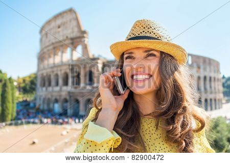 Portrait Of Happy Young Woman Talking Mobile Phone In Front Of C
