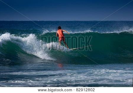 Surfer riding on the wave with long board. Midigama beach, Sri Lanka