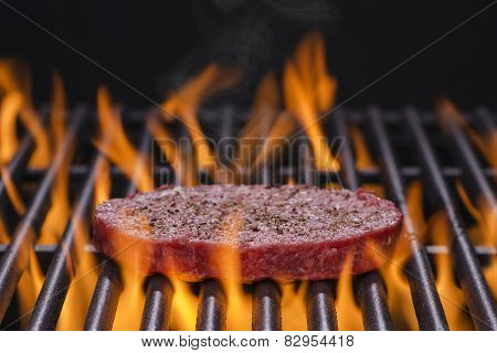 Hamburger Patty on a Hot Flaming Grill