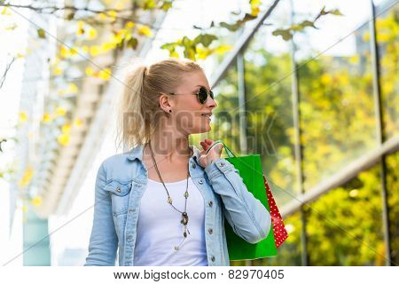 Girl walking down the street with shopping bags