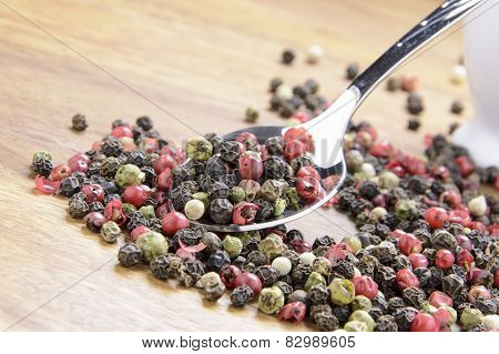 pepper sprinkled on raw wood.