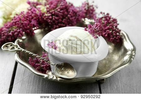 Beautiful composition with tasty ice cream and lilac flowers