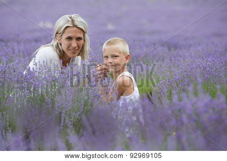 Blonde mother and her son together in lavender field