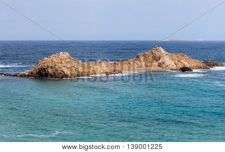small islet in Turquoise water Mediterranean Sea