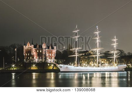 Red Castle And A Boat At Night In Stockholm, Sweden
