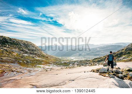 Young Man Goes On A Mountain Hiking Trail In The Mountains Of Norway. Landscape Of Norwegian Mountains. Nature Of Norway. Travel And Hiking. Amazing Scenic View At Sunny Summer Day. Scandinavia. Blue Sky