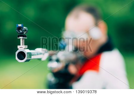Man on free rifle triaing outdoors, selective focus
