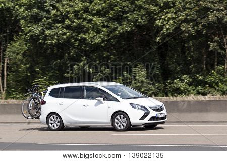 FRANKFURT GERMANY - JULY 12 2016: Third generation Opel Zafira Tourer compact MPV on the highway in Germany