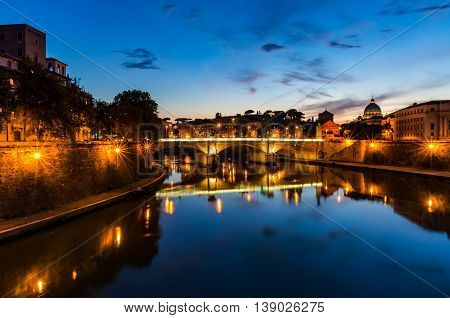 Castle Saint Angel and bridge over the Tiber river on sunset. Night cityscape of Rome landmarks with copy space. Italy