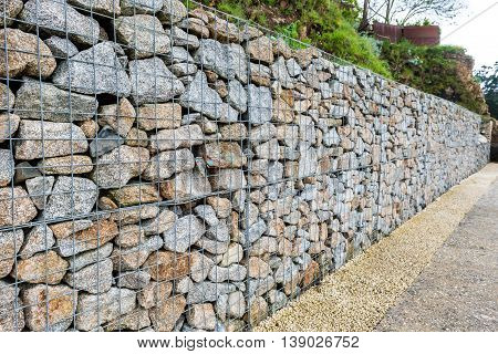Wire Gabion Rock Fence. Metal Cage Filled With Rocks.