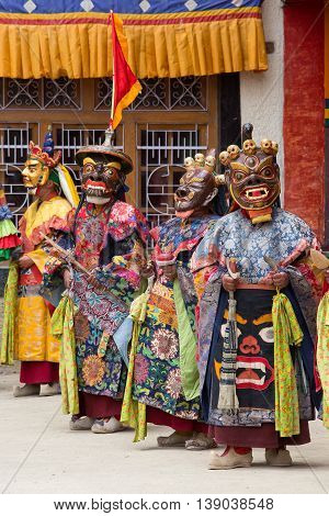 LAMAYURU INDIA - JUNE 13 2015: Unidentified buddhist lamas dressed in mystical mask dancing Tsam mystery dance in time of Yuru Kabgyat Buddhist festival at Lamayuru Gompa Ladakh North India
