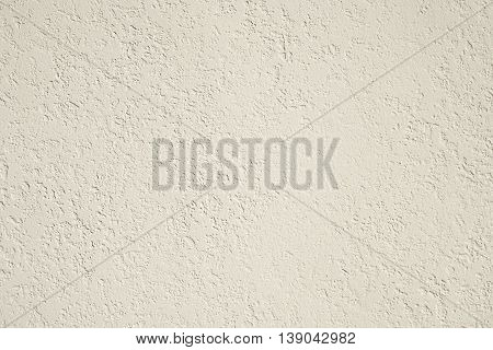 roughcast plaster wall background texture in off-white