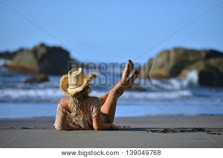 young woman relaxing on the beach in summer day
