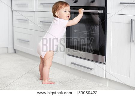Child playing with electric oven