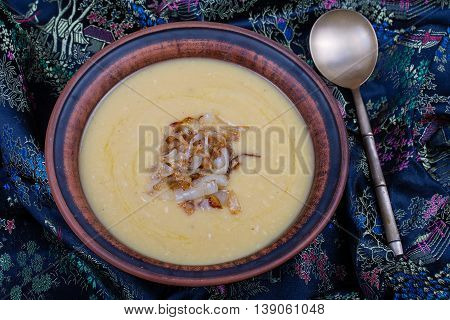 Pea mash with fried onions in a plate close up