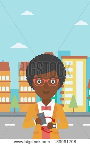 An african-american woman holding a smartphone looking at her smart watch. Synchronization between smartwatch and smartphone. Vector flat design illustration. Vertical layout.