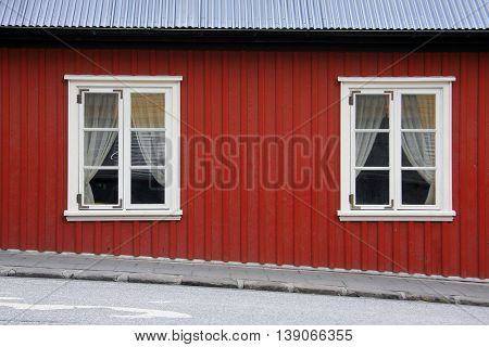 Scandinavian style red house on the street in Iceland.
