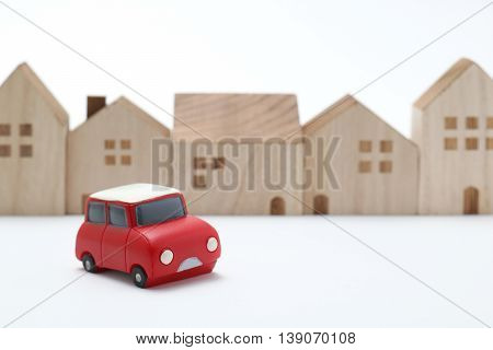 Miniature car and houses on white back ground.
Car sharing concept.