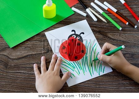 Child Draws Items On A Paper Card. The Child Makes A Postcard With Ladybird. Glue, Paper, Scissors O