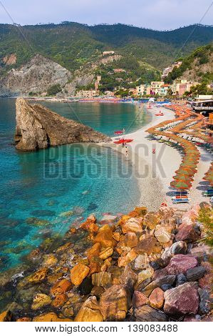 Monterosso Italy - July 02 2016: beach scene in Monterosso al Mare with unidentified people. Monterosso is one of the famous five UNESCO protected picturesque towns in the Cinque Terre