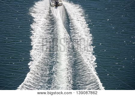 Trail on sea surface behind of speed boats