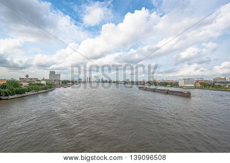 Tugboat towing freighter in Chao Praya River - Bangkok Thailand