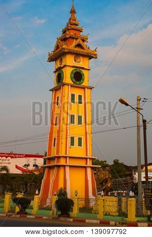 The high clock tower on the street. Bago in Myanmar. Burma.